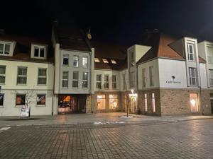 a group of buildings on a street at night at Apartament Nad Zalewem in Kamień Pomorski