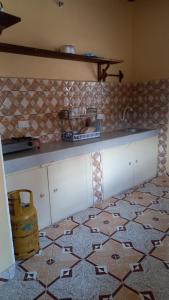 a kitchen with a counter and a tile floor at JAHA in Lamu