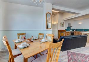 een eetkamer en een woonkamer met een tafel en stoelen bij Oddicombe Hall Flat 2 in Torquay