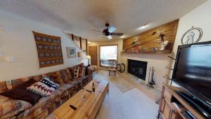 een woonkamer met een bank en een flatscreen-tv bij Grandview 12 Townhouse With High Speed Wifi in Red River