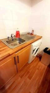 a kitchen with a sink and a microwave at Entire One Bedroom Apartment Near Stratford in London