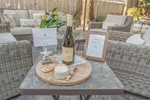 a table with a bottle of wine and a plate of food at 3874 Mission Fields home in Carmel