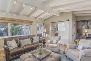 a living room with a couch and chairs and a table at 3874 Mission Fields home in Carmel