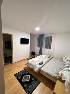 a bedroom with a large bed and a flat screen tv at Pensiunea RNB Maramures in Şurdeşti