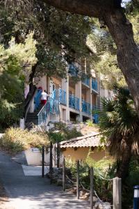 a building with blue railing and people on the stairs at Le Pescadou in Martigues