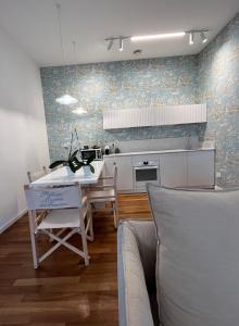 a kitchen with a table and a dining room at Platessa in Portovenere