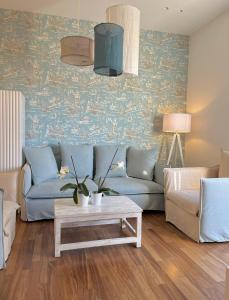 a living room with a blue couch and a table at Platessa in Portovenere