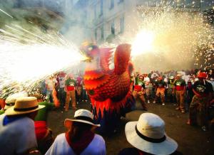 a crowd of people watching a performer in a parade with fireworks at Exclusiva Villa de Lujo con piscina in Canyelles +159 photos