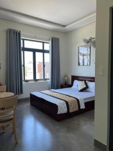 a bedroom with a bed and a large window at Hotel Hòa Bình in Binh Chau +23 photos