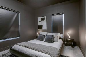 a bedroom with a bed and a large window at Elegant Black Modern in Lincoln +11 photos