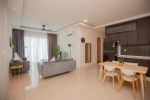 a living room with a couch and a table at Good Seaview Condo, near Queensbay in Bayan Lepas