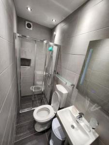a bathroom with a shower and a toilet and a sink at Sunny rooms in Dubrovnik +5 photos
