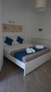 Un dormitorio con una cama grande con almohadas azules. en Il Sogno di SaZa, en Castellana Grotte
