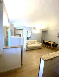 a living room with a white couch and a table at Casa Massey in Turin