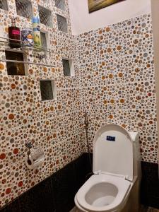 a bathroom with a white toilet in a room at Lala Panzi Bed and Breakfast in Puerto Princesa City