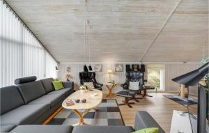 a living room with a couch and a table at Holiday Home Mosebøllevej Thisted Denm in Nørre Vorupør