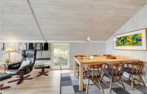 a dining room with a table and chairs at Holiday Home Mosebøllevej Thisted Denm in Nørre Vorupør +18 photos