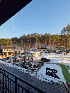 a group of benches on a walkway with snow at Apartman Blago Zlatibora in Zlatibor