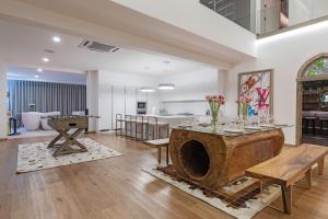 a large living room with a table and chairs at Palm Villa - Award Winning Modern Luxury & Exclusive Villa Resort in Chiang Mai