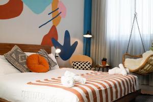 a bedroom with a bed with towels on it at Selina Frishman Tel Aviv in Tel Aviv