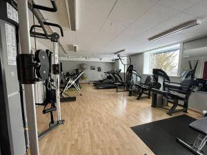 un gimnasio con filas de cintas de correr y equipos de ejercicio en Hotell Villa Långbers, en Tällberg