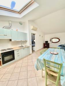 a kitchen and living room with a table and chairs at Berenice in Rio Marina