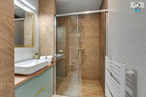 a bathroom with a sink and a shower at MS Apartments Rest 1.0 in Sopot