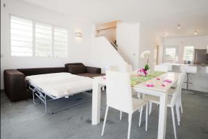 a living room with a table and a couch at Antigua chiama Italia villas in Jolly Harbour