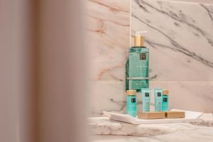 a bottle of mouthwash and other products on a bathroom counter at Occidental Faro in Faro