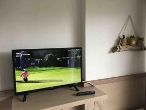 a flat screen tv sitting on top of a table at Studio Golf piscine D Day in Port-en-Bessin-Huppain