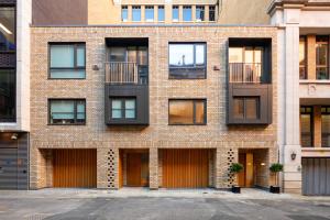 a brick building with windows and a parking lot at Luxury Central Mayfair Townhouse with A/C 3BR 3BA in London