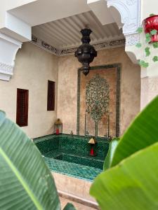 a room with a green floor and a painting on the wall at Riad Sassa Finda in Marrakesh