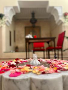 a table with a white table cloth with flowers on it at Riad Sassa Finda in Marrakesh