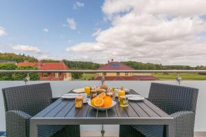 a table with a plate of food on a balcony at VILLA LIFESTYLE _ HONEYMOON_SUITE in Göhren-Lebbin +32 photos