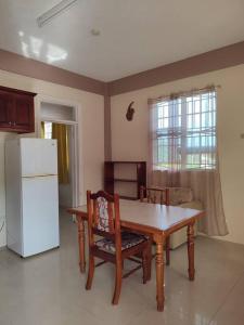 a kitchen with a table and a white refrigerator at Iso’s Vacation Rental Apartment #8 in Portsmouth