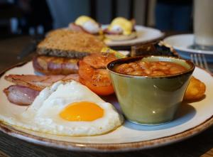 a plate of breakfast food with an egg and beans at The Crown Inn in Coniston