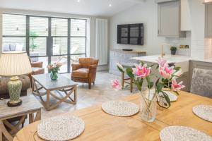 a kitchen and living room with a table and chairs at Historic City Centre Town House in Chester