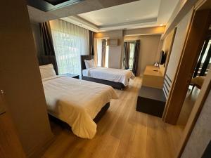 Postel nebo postele na pokoji v ubytování Şehrar Suite Hotel