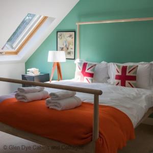 a bedroom with a bed with pillows on it at Number 4 Steading Cottage in Banchory