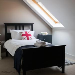 a bedroom with a bed with a black bed frame at Number 4 Steading Cottage in Banchory