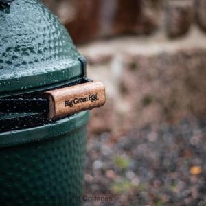 a green trash can with a wooden tag on it at Number 4 Steading Cottage in Banchory