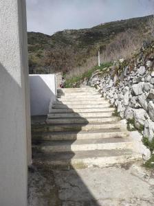a set of stairs leading up to a building at Platanaki Mountain Home 