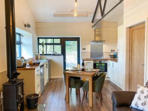 a kitchen with a table and a kitchen with a stove at Serenity- Uk38551 in Endon