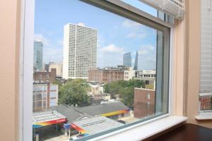 a window with a view of a city skyline at Rittenhouse Square 2BR Apartment in Philadelphia