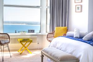 a bedroom with a bed and a large window at No4 St Ives in St Ives