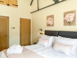 a bedroom with a bed with two towels on it at Serenity- Uk38551 in Endon