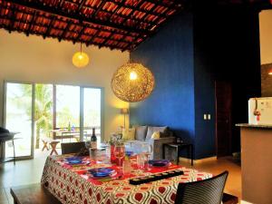 a dining room with a table with plates and glasses at Natal Casa de Playa Paraiso in Pitangui
