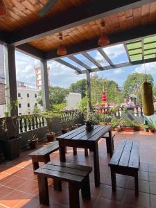 a patio with two wooden benches and a table at New! 1min to JonkerStreet Melaka loft 4BR 11 PAX in Melaka