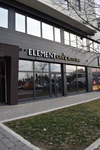 a building with a sign for the entrance to a car dealership at Hotel Element in Novi Sad