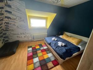 a bedroom with a bed with a colorful rug at obermaubach-am see Apartments in Kreuzau